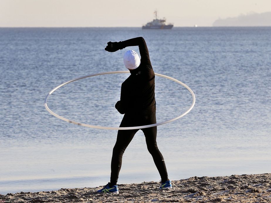 تمرین مرد ورزشکار در ساحل دریای بالتیک